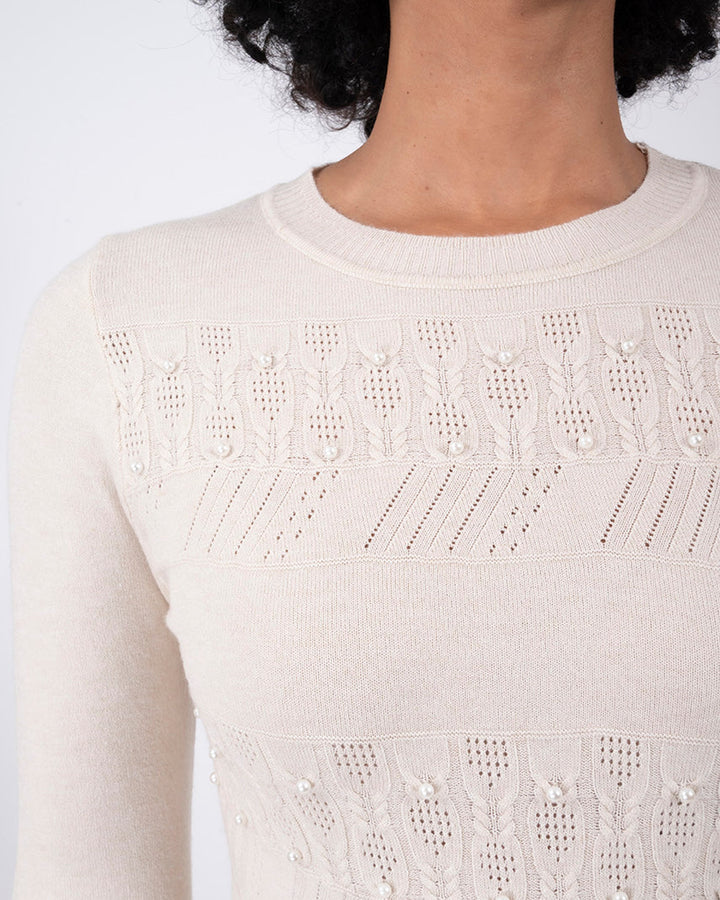 Suéter Elegante con Detalles Beige – detalle de la prenda